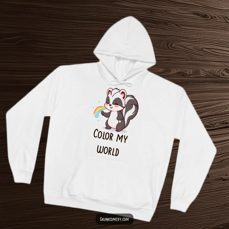 Funny skunk hoodie showing a cute skunk happily spraying a vivid rainbow, perfect for chilly days.