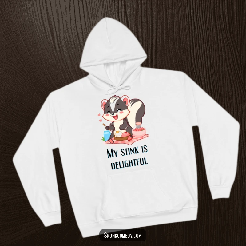 Funny skunk hoodie depicting a smiling skunk happily sharing a picnic spread, emphasizing warmth and fun.