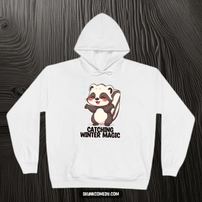 Funny skunk catching a snowflake with outstretched paws, warm hooded sweatshirt, cute winter animal, humorous graphic, gift.