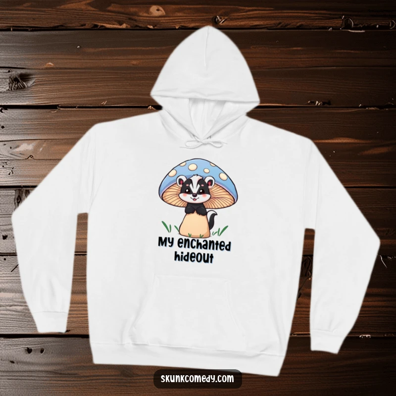 Funny skunk hoodie showing a skunk peeking with wonder from behind a large, colorful mushroom, offering warmth and charm.