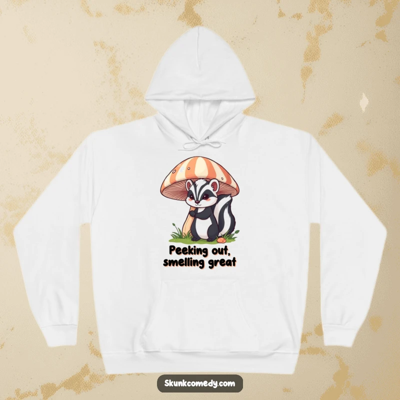 Funny skunk hoodie featuring a skunk peeking out from behind a large, striped mushroom, perfect for cozy, curious days.