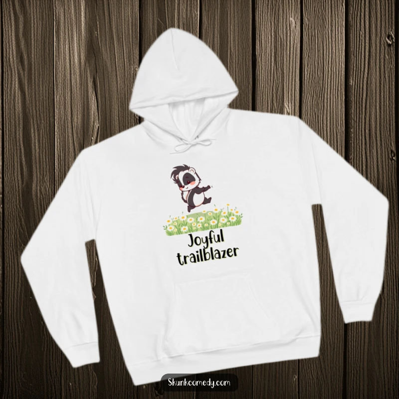 Funny skunk hoodie depicting a happy skunk skipping through a field of daisies, offering cozy comfort and whimsical humor.
