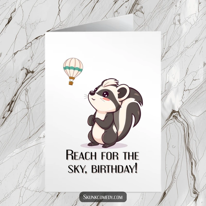 Funny free printable birthday card of a skunk gazing with wide-eyed excitement at a colorful hot air balloon overhead.