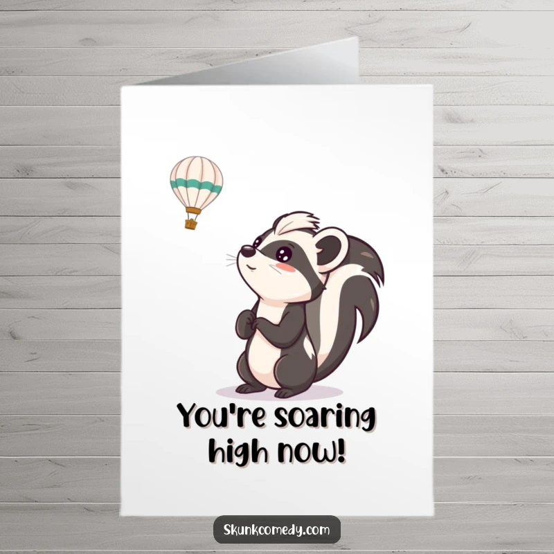 Funny free printable congratulations card of a skunk looking up in awe at a passing hot air balloon.