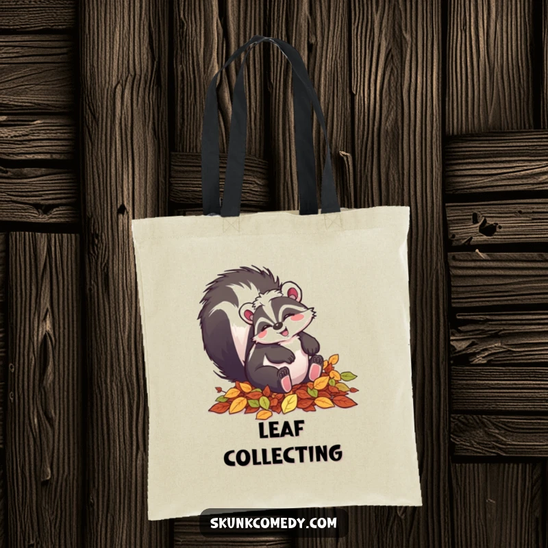 Funny skunk tote bag featuring a happy skunk tumbling in autumn leaves, perfect for fall outings.